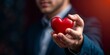 © Helen Marlen - Heartfelt Gesture: Man Holding Red Heart Symbol