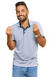 © Krakenimages.com - Handsome man with beard wearing casual clothes doing money gesture with hands, asking for salary payment, millionaire business