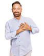 © Krakenimages.com - Handsome middle age man wearing business shirt smiling with hands on chest with closed eyes and grateful gesture on face. health concept.