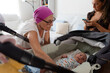 © Raul Navarro/Stocksy - Grandmother caring at newborn grandson