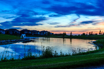 Wall Mural - A serene lake with a fountain in the background