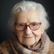 © StockUp - A close-up portrait of an elderly woman with glasses, smiling gently at the camera with warm eyes.