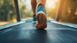 © melvilsky - Person exercises on a treadmill in an outdoor park during sunset, enjoying a healthy fitness routine
