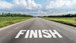 © Nazlykhan - Open road with finish line under blue sky and clouds