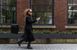 © Eva Plevier/Stocksy - Modern Businesswoman walking on the street on the phone.
