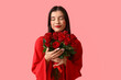 © Pixel-Shot - Beautiful young woman with kiss marks on her face and bouquet of roses on pink background