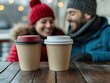 © taweesak - A couple smiling at each other over coffee, warm tones, focus on the background for text