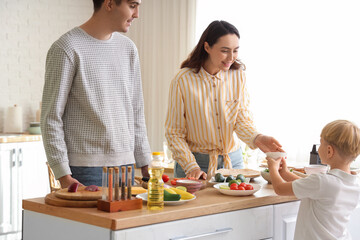 Wall Mural - Cute little boy with his parents cooking Fajita in kitchen