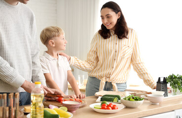 Wall Mural - Cute little boy with his parents cooking Fajita in kitchen