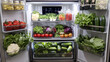 © Aditya - A well-organized refrigerator filled with fresh produce.  Crisper drawers overflow with leafy greens, tomatoes, cucumbers, and other vegetables. Jars of pickled goods are on the top shelf.