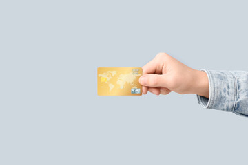 Wall Mural - Young man holding credit card on light background