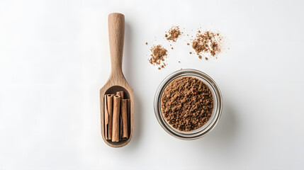 Canvas Print - Cinnamon sticks and ground cinnamon powder in a wooden scoop and glass bowl.  Aromatic spice, perfect for baking and cooking. Top view on white background.