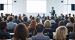 © VistaVisions - Audience with blurred speaker giving presentation in bright university workshop lecture hall background. Scientific conference presentation event, training, meeting