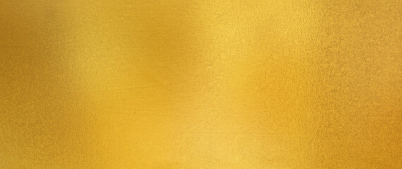 gold wall texture background. yellow shiny gold foil paint on wall surface with light reflection, vi