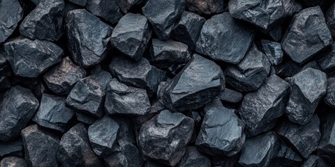 Aufkleber - Large pieces of black coal arranged in a pile create a striking background. The texture of the black coal adds depth and character to the visual, making it an impactful image of black coal.