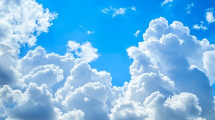 Poster - Fluffy white clouds drift peacefully across the bright blue sky, creating a serene and picturesque scene of white clouds against a vibrant blue sky, perfect for capturing the beauty of nature.
