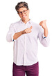 © Krakenimages.com - Young handsome man wearing business clothes and glasses pointing to the back behind with hand and thumbs up, smiling confident