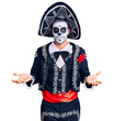 © Krakenimages.com - Young man wearing day of the dead costume over background clueless and confused expression with arms and hands raised. doubt concept.