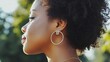 © Atthapon - A woman with a gold hoop earring