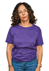 Wall Mural - middle age hispanic woman wearing casual clothes relaxed with serious expression on face. simple and