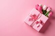 © Антонина Кузнецова - A beautiful gift box with a pink bow and tulips on a pink background. Valentine's Day, Happy Women's Day, Mother's Day, Birthday, Wedding, Christmas. place for the text