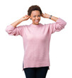 © Krakenimages.com - Beautiful young african american woman over isolated background Smiling pulling ears with fingers, funny gesture. Audition problem