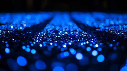 Fototapete - Blue glowing particles on dark background with bokeh effect