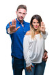 © Krakenimages.com - Young couple in love over isolated background doing stop sing with palm of the hand. Warning expression with negative and serious gesture on the face.