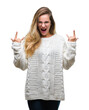 © Krakenimages.com - Young beautiful blonde woman wearing winter sweater and sunglasses over isolated background shouting with crazy expression doing rock symbol with hands up. Music star. Heavy concept.