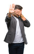 © Krakenimages.com - Young handsome business man over isolated background covering eyes with hands and doing stop gesture with sad and fear expression. Embarrassed and negative concept.