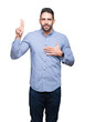 © Krakenimages.com - Young handsome man over isolated background Swearing with hand on chest and fingers, making a loyalty promise oath