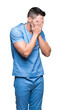 © Krakenimages.com - Handsome young doctor surgeon man over isolated background with sad expression covering face with hands while crying. Depression concept.