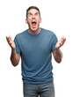 © Krakenimages.com - Handsome young casual man crazy and mad shouting and yelling with aggressive expression and arms raised. Frustration concept.