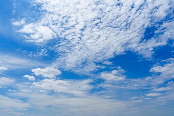 Wall Mural - a breathtaking view of a stunning blue sky adorned with fluffy white clouds, creating a serene and p