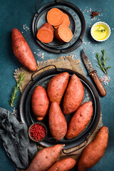 Wall Mural - Raw sweet potatoes on a metal tray. Organic farm potatoes.