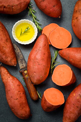 Wall Mural - Raw organic sweet potatoes. Vertical photo, top view, close-up.