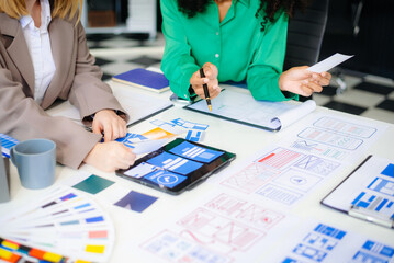 Wall Mural - ux developer and ui designer brainstorming about mobile app interface wireframe design with customer