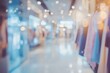 © BerkahStock - Blurred image of a clothing store interior with racks of clothes and shoppers.