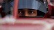 © ivanbaranov - Close-up of a focused pilot driver in a red racing car, preparing for a race
