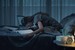 © StockPhotoPro - Exhausted student staying up at night and preparing for the exam