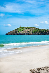 Wall Mural - Lighthouse is on a hill overlooking the ocean