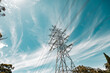 © Austockphoto - Electricity pylon with dramatic clouds and blue sky, symbolizing power and energy.