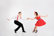 © deagreez - Full length photo of two young people hold arms enjoy dancing performance isolated on white color background