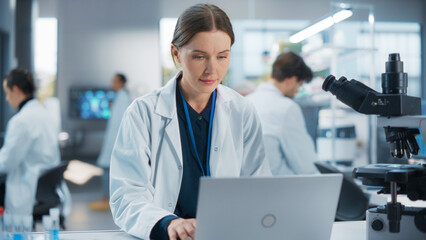 Aufkleber - Caucasian Female Medical Research Scientist Work on a New Generation Medical Products in a Modern Laboratory. Young Woman Working on a Laptop Computer, Browsing Research Data Online