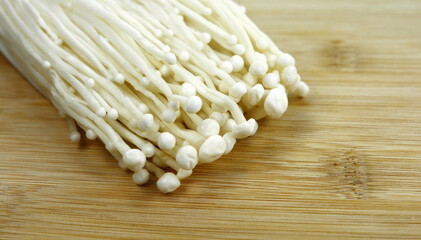 Wall Mural - Enoki mushrooms on the cutting board.