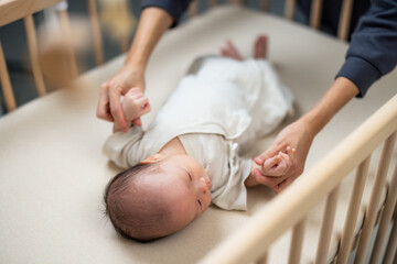 Wall Mural - Mum help baby to do exercise on hand