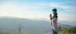 © sutlafk - Asian woman in black sweater standing fresh morning hold hot coffee cup at nature mountain on dreaming sunny day, relax and freedom day. Lifestyle Concept.