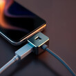 © Zack Ahmad - Modern Smartphone Charging with Sleek Connector. Close-up of a modern smartphone connected to a charging adapter.