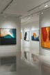 © Сергей Захаров - contemporary art gallery illuminated by track lighting with abstract paintings creating focal points on white walls