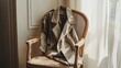 © adobestocker1 - A stylish trench coat draped over a light wooden chair